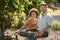 Portrait Of Couple Working In Vegetable Garden Or Allotment Carrying Tray Of Beets