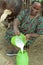 Portrait of cow milking Ethiopian woman