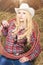 Portrait of Cowgirl With Lasso Rope in Cattleshed