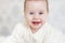 Portrait of a crawling baby on the bed in her room