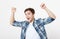 Portrait crazy excited happy man standing with raised hands and looking at camera isolated on white background. Student Pass exam