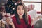 Portrait of crazy girl hold smartphone x-mas noel bargain concept sit couch in house indoors with christmas decoration