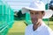 Portrait of cricketer standing at field