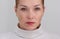 Portrait of cropped caucasian middle aged woman face with freckles on white background