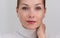 Portrait of cropped caucasian middle aged woman face with freckles on white background