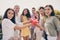 Portrait of crowd of positive fellows hands hold cup clink have a good mood meeting cafe roof outdoors