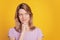 Portrait of cunning playful lady look empty space finger chin clever face on yellow background