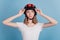 Portrait of curious dreamy lady wear motorcycle helmet look empty space on blue background