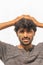 Portrait of curious or tense Young Indian male Cricket sports fan Painted Indian flag on his face