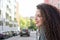 Portrait of curly-haired young woman on the street. Latin woman. Arab woman