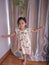 Portrait cute 3 year old Asian little girl wearing a summer fashion clothes and accesories posing indoor