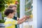 Portrait of cute adorable white Caucasian funny child boy looking at ice cream in shop window, trying to choose one, looking