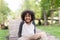 Portrait of a cute African american little boy smiling at nature park