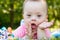 Portrait of Cute baby boy with Down syndrome lying on blanket in summer day on nature