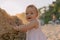 Portrait of cute baby in dress on ocean beach with sunset sunshine