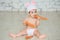 Portrait of a cute baby dressed in Easter bunny ears sitting and