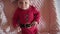 Portrait of a Cute Baby Santa lying in a suit of Santa Claus, in a red hat, red pajamas. Christmas concept. Camera down