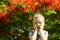 Portrait of a cute blond boy. A 5-year-old child laughs in front of a blooming Delonix regia. Place for text. Emotions