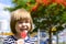 Portrait of a cute boy with candy on the background of a bright playground.