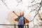 Portrait of cute boy on climbing frame holding hand up