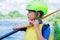 Portrait of cute boy kayaking on the river on a sunny day during summer vacation