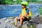 Portrait of cute boy kayaking on the river on a sunny day during summer vacation