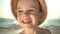 Portrait cute boy in a straw hat on the beach