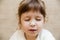 Portrait of cute brunette baby girl is preparing in kitchen. Funny  little girl is covered in flour.Children chef concept.Happy