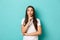 Portrait of cute brunette girl in white t-shirt, hushing with finger over lips, telling a secret, asking to keep quiet