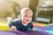 Portrait of cute caucasian baby boy crawling on soft playing mat indoors. Adorable child having fun making making first steps on f