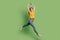 Portrait of cute charming ballerina lady jump dance wear yellow t-shirt jeans footwear on green background