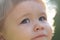 Portrait of a cute child boy. Close up caucasian Baby kids cropped macro face. Closeup head of funny kid outdoor.