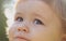 Portrait of a cute child boy. Close up caucasian Baby kids cropped macro face. Closeup head of funny kid outdoor.