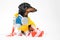 Portrait a cute dachshund dog, wearing in a yellow hazmat suit with self contained breathing apparatus, lies on the signal tape