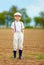 Portrait of cute farmer boy on spring field