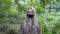 Portrait of a cute girl, blonde, wearing a black protective mask on her face, who looks at the camera, standing in the