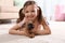 Portrait of cute girl with funny Brussels Griffon dog at home