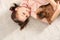 Portrait of cute girl with funny Brussels Griffon dog lying on carpet. Loyal friends