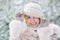 Portrait of a cute girl holds on a hands a knitted hat in a winter