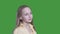 Portrait cute girl with long blond hair winding on green background. Romantic teenager girl looking away on chroma key