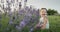 Portrait of a cute girl sitting near lavender bushes.