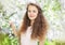 Portrait of cute girl in the spring flowering garden