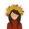 Portrait of a cute girl in a wreath of autumn leaves on her head