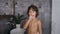 Portrait of a cute and handsome five or six years boy with curly hairs in white towel brushing his teeth using
