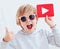 Portrait of cute happy boy, kid with play button icon and thumb up