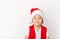 Portrait of cute happy smiling child in red Santa Claus hat isolated on white background. Beautiful five-year European boy. Merry