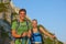 PORTRAIT: Cute hiker couple smiles after reaching the mountaintop in the Alps.