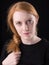 Portrait of a cute Irish redhead female. Closeup of head and face.