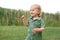 Portrait of a cute little boy on the background of reeds. Walk in park. Family life