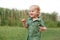 Portrait of a cute little boy on the background of reeds. Walk in park. Family life